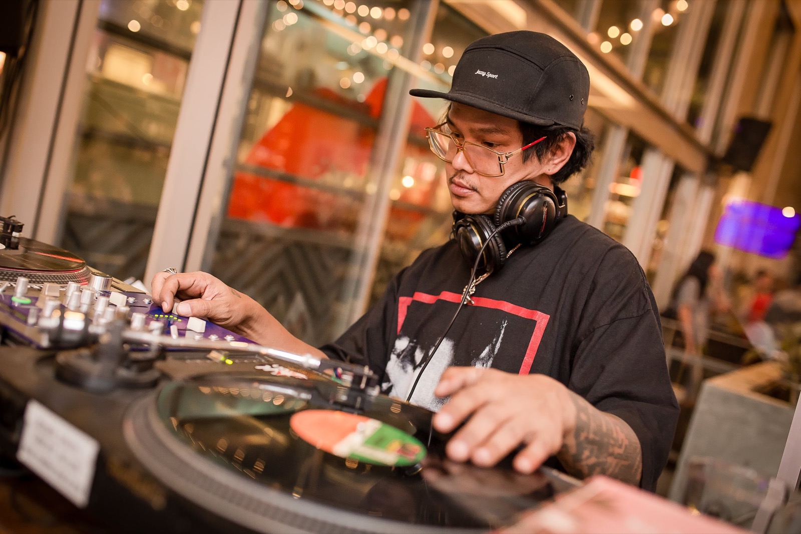 A DJ playing vinyl at The Beer Cap