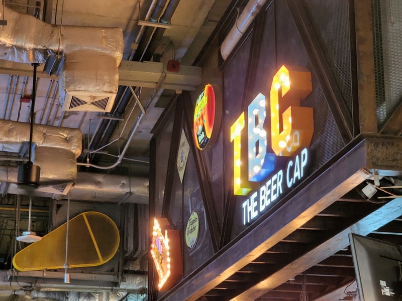 The illuminated TBC marquee sign inside The Beer Cap